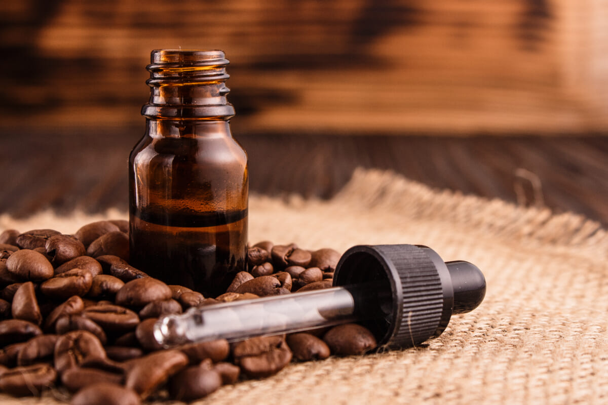 essential oil of coffee beans on a wooden background | コーヒーステーション