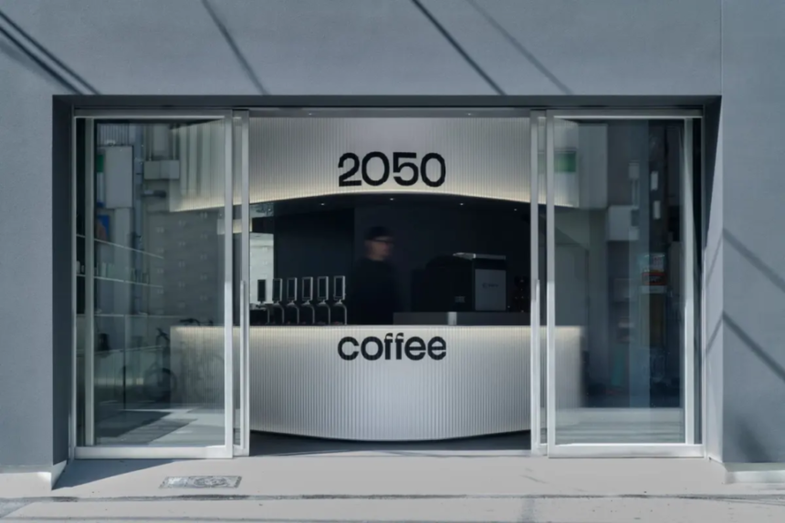Futuristic coffee shop counter visible through glass doors with 2050 above and coffee on the front panel