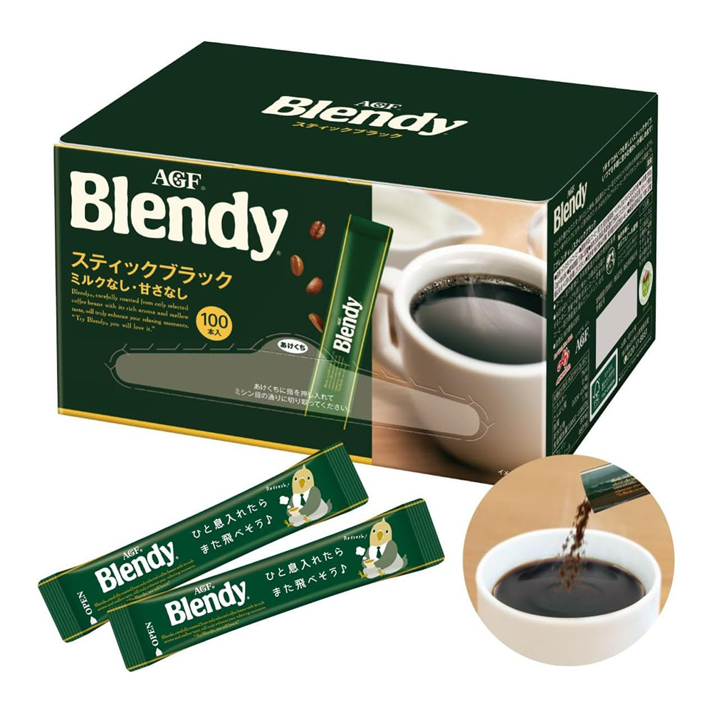 Box of AGF Blendy coffee sticks with two green sachets and a cup of black coffee in the background