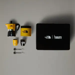 The North Face x Bialetti coffee set yellow and black moka pot cups spoons and a black logo box on a gray background