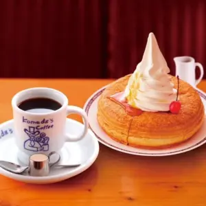 bbca7e12938e95a91006a76f08ae8722 | コーヒーステーション Cup of black coffee in a Komedas Coffee mug on a saucer beside a tall cream topped pancake with a cherry on top