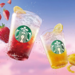 Two Starbucks iced drinks with strawberry and lemon fruit accents shown mid air with splashes against a pink blue sky