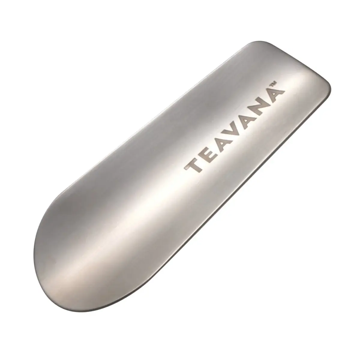 白背景に置かれた、つや消し加工の施された銀色の茶さじです。表面には「TEAVANA™」のロゴが刻印されており、シンプルなデザインのキッチン用品であることがわかります。