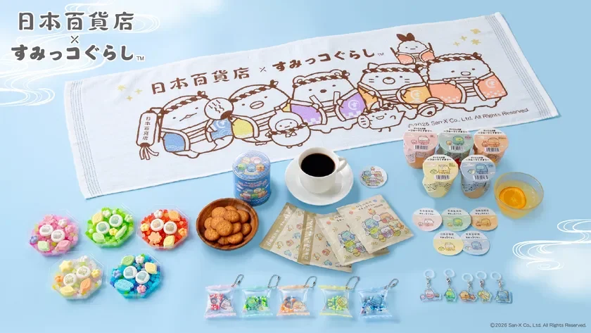 Assortment of colorful Japanese candies and snacks arranged on a light blue surface with a white towel featuring Sumikko Gurashi characters in the background