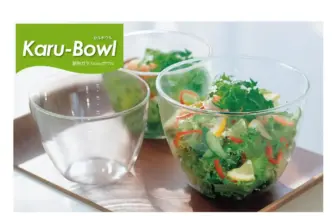 Glass bowls on a wooden tray with a fresh salad in the right bowl; green Kar-Bowl logo in the top-left corner.