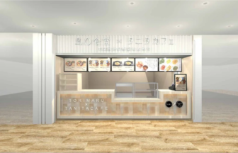 Modern cafe counter inside a light open storefront with menu boards above and a wood toned front featuring TORIMARU x TANITA CAFE design