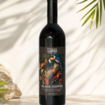 Bottle of Paikaji Coffee Black Coffee with a vibrant tropical label on a light stone surface outdoors
