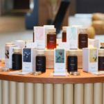 Round wooden table displaying multiple Temitu bottles and matching boxed products with pastel labels in a retail setup