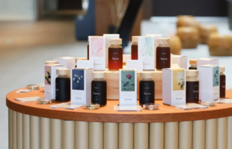 Round wooden table displaying multiple Temitu bottles and matching boxed products with pastel labels in a retail setup