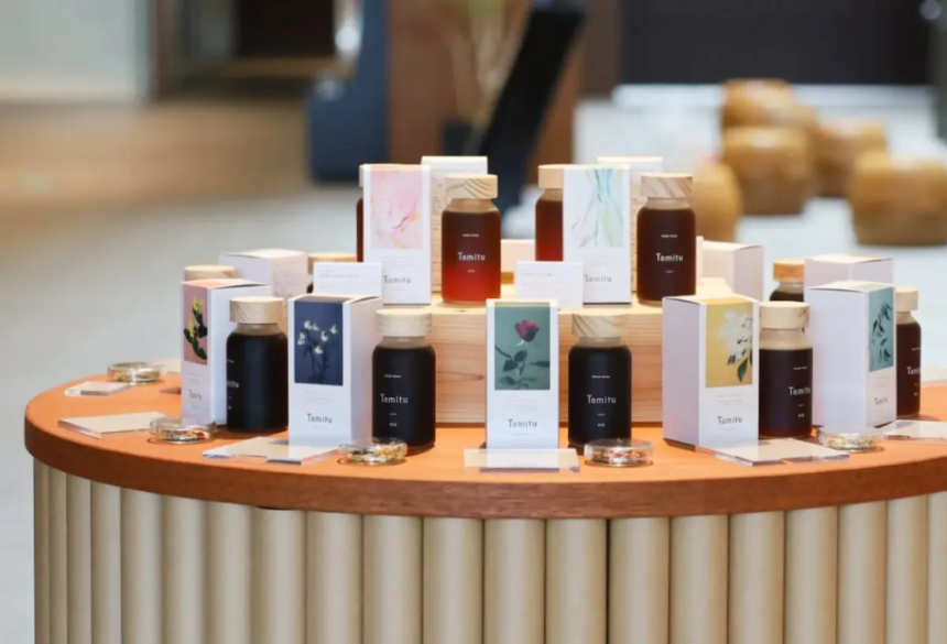 Round wooden table displaying multiple Temitu bottles and matching boxed products with pastel labels in a retail setup