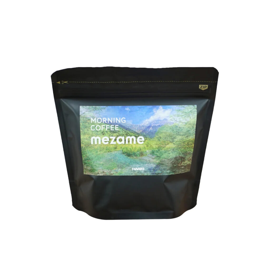 2100b05c58859e58438c8148d06669f5b823 | コーヒーステーション Black resealable coffee bag with a nature landscape label that reads Morning Coffee mezame on the front