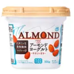 Cup of almond yogurt labeled The ALMOND with almonds on the front and a beige lid packaging shows Japanese text and 300 g unit size
