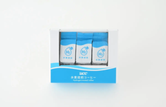 Box of UCC hydrogen-roasted coffee sachets, three blue-and-white packets visible in a display case.