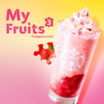 Advertising image for My Fruits 3 Frappuccino with a pink blended drink topped with whipped cream strawberry pieces and a yellow pink gradient background