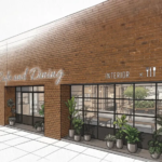 Exterior of a brick c walkway cafe with a large glass storefront interior dining space visible through windows potted plants outside