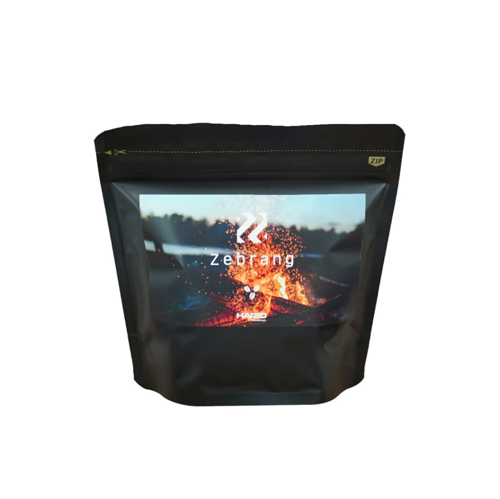 6100f3ec9eab4854492194bbe5fdbc03e82b | コーヒーステーション Black stand up pouch with a front label showing a fiery background and the word zebrang product packaging
