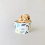 Scooped beige gelato in a patterned cup labeled Gelateria Santi