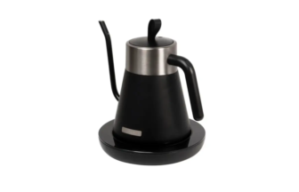Black electric kettle with stainless steel lid on a round base ready for use in tea or coffee brewing