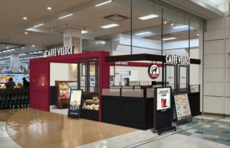 Cafe kiosk named CAFFE VELOCE inside a shopping mall with pink and black decor and menu boards outside