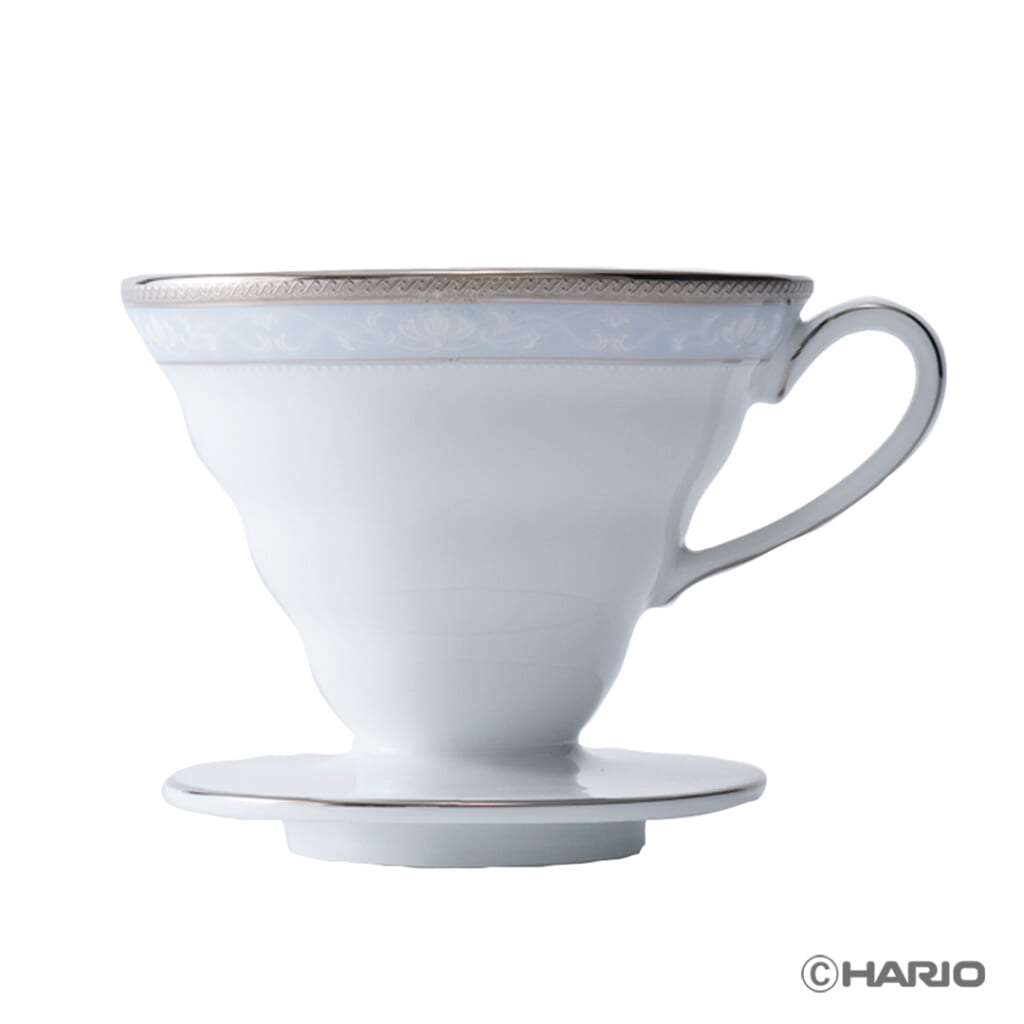 White ceramic pour over coffee dripper with a handle and saucer shown from the side