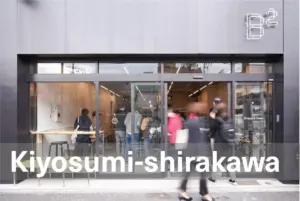 Glass front bakerycafe storefront with customers inside large white text Kiyosumi shirakawa across the bottom