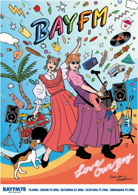 Two women in colorful dresses sing on a stage with guitars and drums under a bright BayFM banner