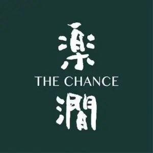 Logo with white Chinese characters flanking the English text THE CHANCE on a dark green background