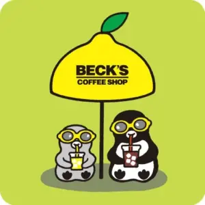 Two penguins wearing yellow glasses sit next to a tall yellow lemon shaped umbrella with the Becks Coffee Shop logo each sipping a drink through straws