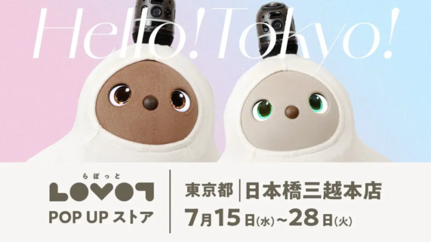 Two LOVOT robot companions in white hooded outfits with pastel pinkblue backdrop advertising the LOVOT Pop Up Store in Tokyo July 1528