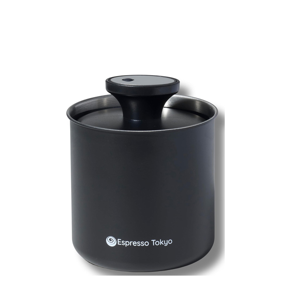 Compact black manual coffee grinder with a rounded lid and Espresso Tokyo logo on the side