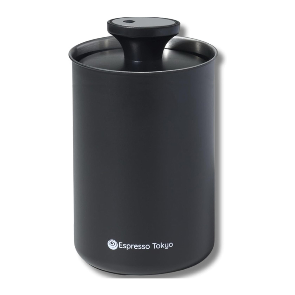 Black cylindrical airtight coffee canister with a domed lid and a built in valve branded'Espresso Tokyo' at the base.