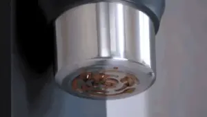 Close up of a chrome grinders interior showing copper blades in the center