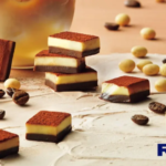 Assorted Royce chocolate squares on a light wooden surface with New in red and a yellow 数量限定 badge