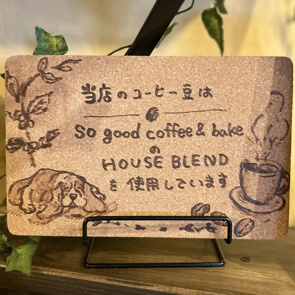 コルクボードの看板。手書きで「当店のコーヒー豆はSo good coffee & bakeのHOUSE BLENDを使用しています」と書かれている