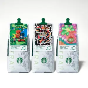 Three Starbucks coffee bags labeled Sumatra Masa Depan with bright abstract artwork on each label and green top clips on a white background side by side