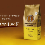 Package of Sarutahiko Coffee Mocha Mild 150g with gold and yellow design logo on front against a warm brown background Japanese branding text on left and vertical slogan on right