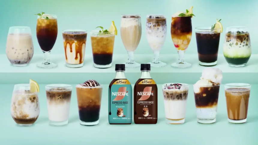 Assorted iced coffee drinks on a mint green shelf with two Nescafe Espresso Base bottles in the center