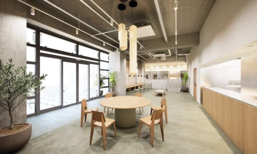 Open plan loungedining area with a round table and wooden chairs large glass doors and potted plants across a concrete ceiling space soft lighting