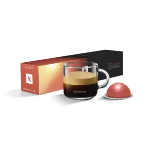 Nespresso coffee set glass cup of dark espresso with crema next to orangeblack box labeled Vertuo Ginseng Delight and pink capsule on the right