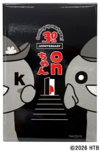 Front cover of a commemorative edition featuring two gray cartoon mascots facing each other against a black background with red Japanese text and a stairway motif celebrating a 30th anniversary