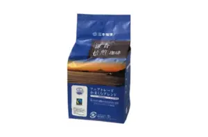 Blue bag of Japanese coffee beans with a sunset landscape label and certification sticker on the front
