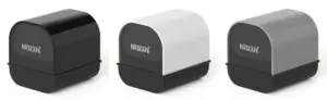 Three compact curved top coffee capsule machinesdispenser units with NESCAFÉ branding in black white and gray from left to right