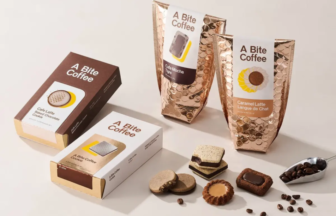Assorted A Bite Coffee chocolate cookies and coffee sachets, with copper foil bags and boxed packaging on a light surface.