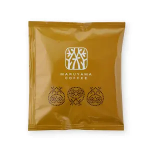 c2e3f0883d619d2adaf1abceb415d3f1 | コーヒーステーション A brown coffee bag with a white logo and the words MARUYAMA COFFEE plus three circular decorative patterns at the bottom left