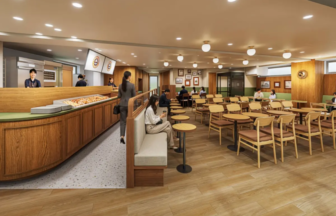 Café interior with a curved wooden counter pastry display and rows of tables and wooden chairs for dining