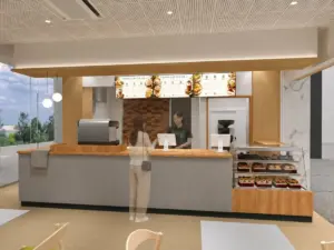 Cafe counter in a shopping mall with pastry case espresso machine and menu boards overhead two staff behind the counter serving a customer