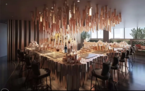 Contemporary dining room with a long U shaped wooden table black chairs and hundreds of hanging wooden cylinders above