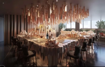 Contemporary dining room with a long U shaped wooden table black chairs and hundreds of hanging wooden cylinders above
