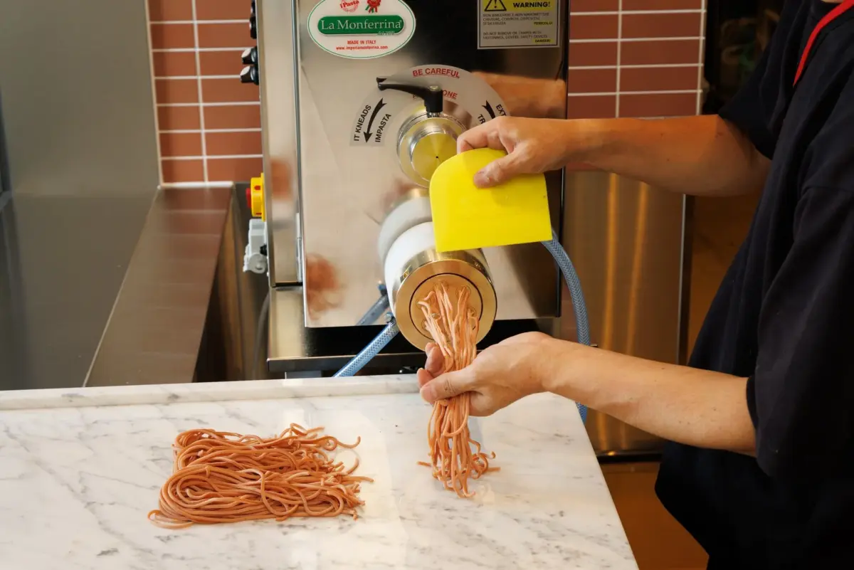 パスタメーカーで生パスタを製麺する様子